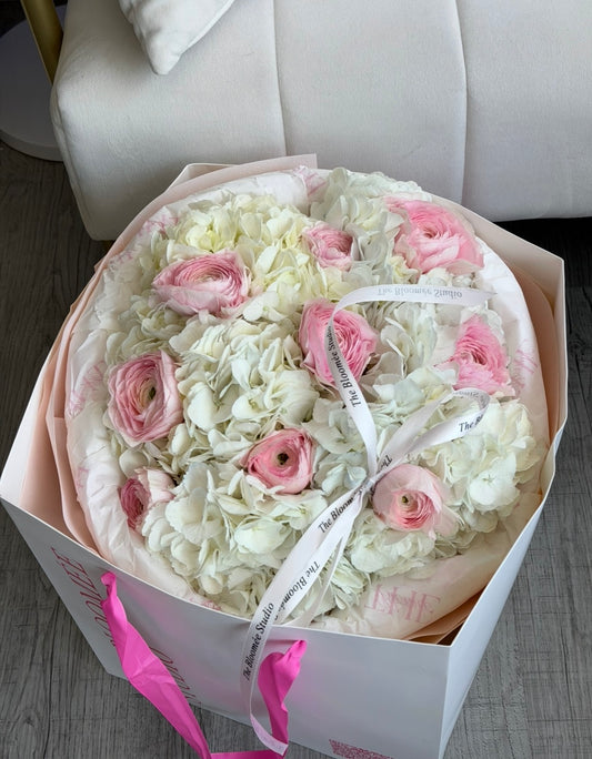 White hydrangeas with pink ranunculus bouquet